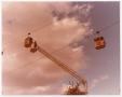Photograph: [Aerial Lift Crane Reaching Towards Sky Tram Car]