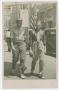 Photograph: [Photograph of Two Men Walking on Elm Street Sidewalk]