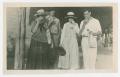 Photograph: [Photograph of Four Individuals by a Building]
