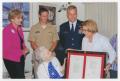 Photograph: [Congresswoman Ileana Ros-Lehtinen Giving a Framed Document to Helen …