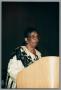 Photograph: [Myrtle Sloane standing behind podium]