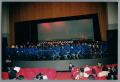 Photograph: [Choir and band sitting on stage]