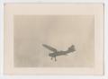 Photograph: [Photograph of a Douglas 0-43A Airplane Above Camp Hulen]